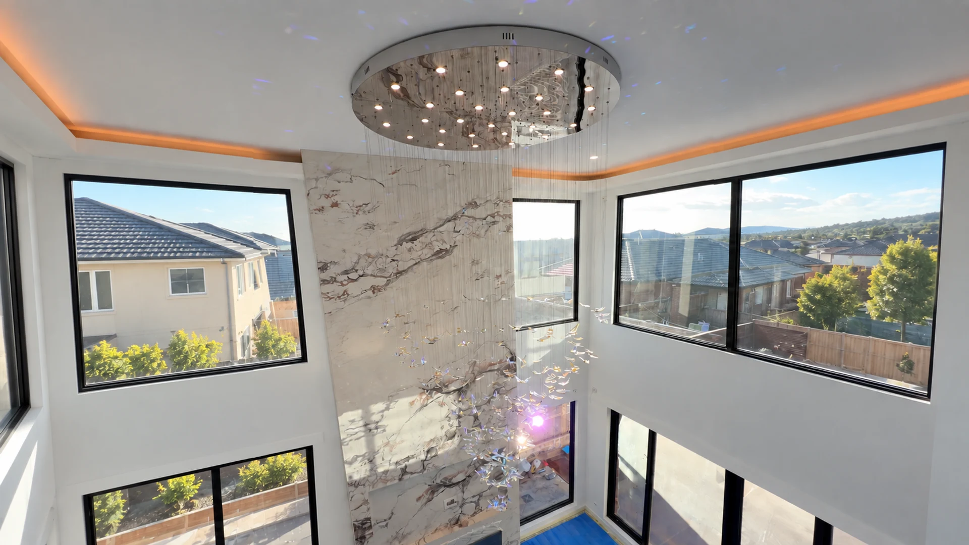 A Voltra chandelier installation in a double-height interior
