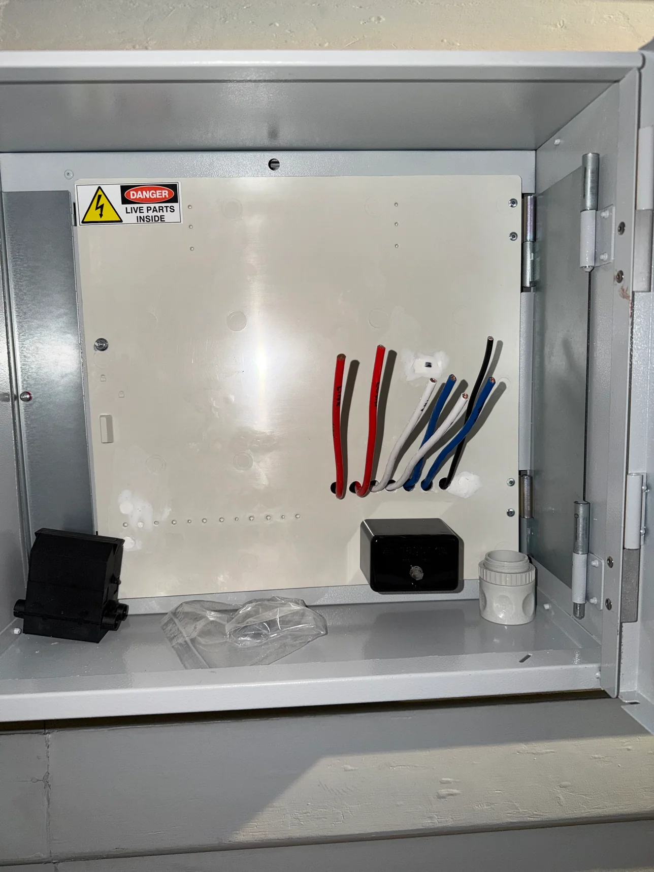 Meter panel with three-phase mains cables prepared before the meter is fitted